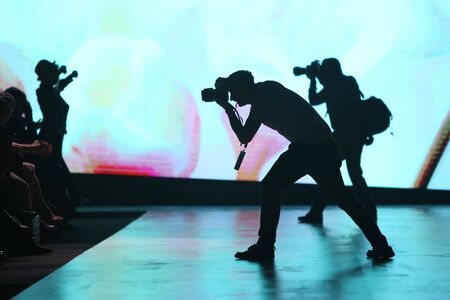 ZAGREB, CROATIA - MARCH 30, 2017 : Silhouette of photographers photographing audience on the Bipa Fashion.hr fashion show in Zagreb, Croatia.のeditorial素材
