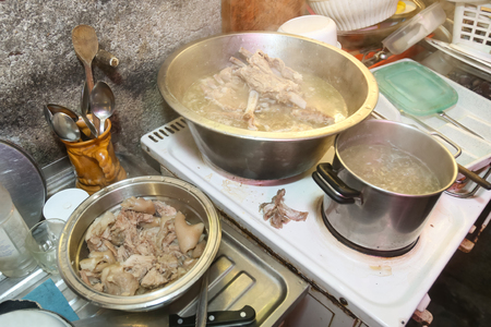 A view of pork meat boiling in the pot on the stove.の写真素材