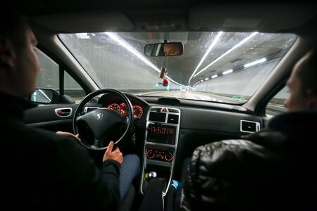 MUNICH, GERMANY - MAY 6, 2017 : Two men driving in a car through a tunnel at night in Munich, Germany.のeditorial素材