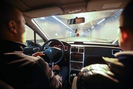 MUNICH, GERMANY - MAY 6, 2017 : Two men driving in a car through a tunnel at night in Munich, Germany.のeditorial素材