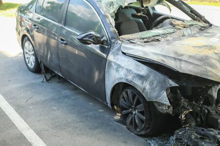 The side view of a burned out car at a parking lot.の写真素材
