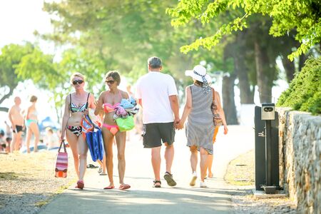 NJIVICE, CROATIA - JUNE 24, 2017 : People walking on the beach in Njivice, island of Krk, Croatia.のeditorial素材