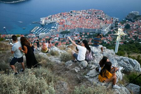 DUBROVNIK, CROATIA - JULY 20, 2017 : Tourists on Srd mountain taking photos of the ancient old town in Dubrovnik, Croatia.のeditorial素材