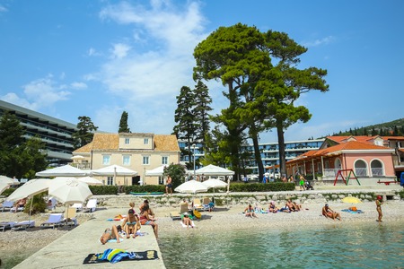 SREBRENO, CROATIA - JULY 22, 2017 : People bathing and sunbathing on sea beach with the Sheraton hotel in the background in Srebreno, Croatia.のeditorial素材
