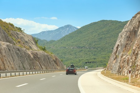 VLAKA, CROATIA - JULY 16, 2017 : A car driving on a highway through the rural landscape in Vlaka, Croatia.のeditorial素材