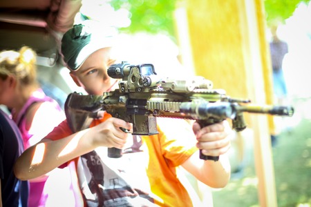 ZAGREB, CROATIA - MAY 28, 2017 : A boy checking the M4 sniper machine gun on the 26th anniversary of the formation of the Croatian Armed Forces on Lake Jarun in Zagreb, Croatia.のeditorial素材