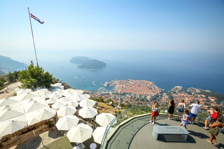 DUBROVNIK, CROATIA - JULY 19, 2017 : Tourists at a viewpoint on Srd hill looking at Dubrovnik panorama in Dubrovnik, Croatia.のeditorial素材