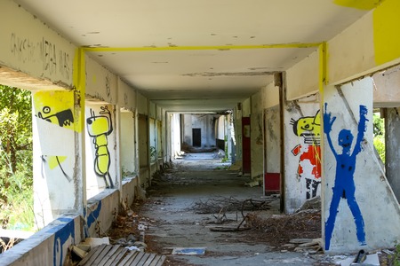 KUPARI, CROATIA - JULY 18, 2017 : Graffiti on the wall of hotel in an abandoned Yugoslavian military resort in Kupari, Croatia.のeditorial素材