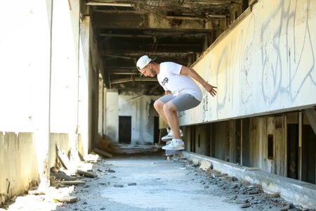 KUPARI, CROATIA - JULY 18, 2017 : A young man skateboarding in an hotel in abandoned Yugoslavian military resort in Kupari, Croatia.のeditorial素材
