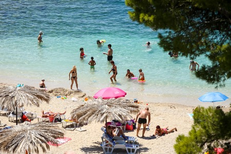 KUPARI, CROATIA - JULY 18, 2017 : People swimming and sunbathing on a sea beach in Kupari, Croatia.のeditorial素材