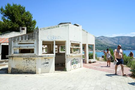 KUPARI, CROATIA - JULY 18, 2017 : People walking through the area of an old abandoned hotel in Kupari, Croatia.のeditorial素材