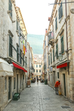 DUBROVNIK, CROATIA - JULY 22, 2017 : A garbage man cleaning the street in the old city core in Dubrovnik, Croatia.のeditorial素材