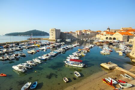 DUBROVNIK, CROATIA - JULY 22, 2017 : Lined up boats moored at the old city harbor in Dubrovnik, Croatia.のeditorial素材