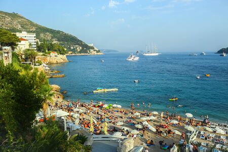 DUBROVNIK, CROATIA - JULY 22, 2017 : People bathing and sunbathing on the city beach Banje in Dubrovnik, Croatia.のeditorial素材