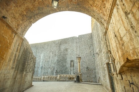 A view of a street with city walls in the old city core in Dubrovnik, Croatia.の写真素材