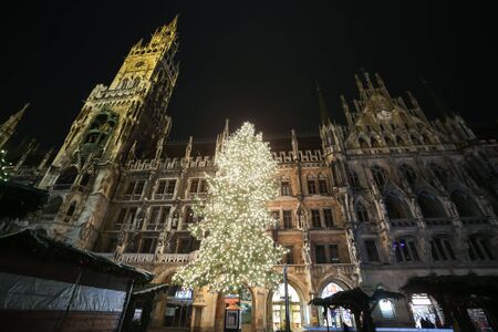 MUNICH, GERMANY - DECEMBER 11, 2017 : A low angle view of the decorated illuminated Christmas tree and the New Town Hall on Marienplatz at night in Munich, Germany.のeditorial素材