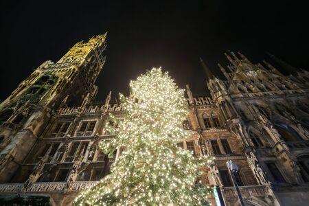 MUNICH, GERMANY - DECEMBER 11, 2017 : A low angle view of the decorated illuminated Christmas tree and the New Town Hall on Marienplatz at night in Munich, Germany.のeditorial素材
