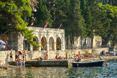 CAVTAT, CROATIA - JULY 20, 2017 : People swimming and sun bathing on the coast of Cavtat, Croatia.のeditorial素材
