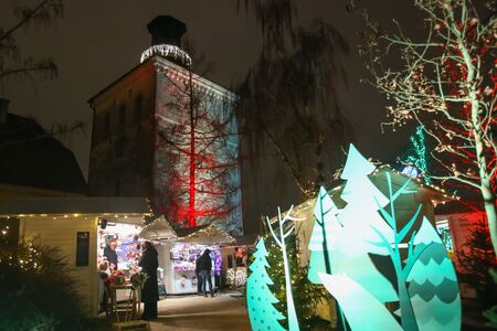 ZAGREB, CROATIA - DECEMBER 13th, 2017: Advent time in city center of Zagreb,Croatia. People sightseeing the food and souvenir stands in the upper old town Gradec with Lotrscak Tower in the background.のeditorial素材