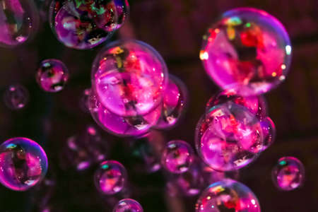 Abstract image of soap bubbles from the bubble blower in dark.の写真素材