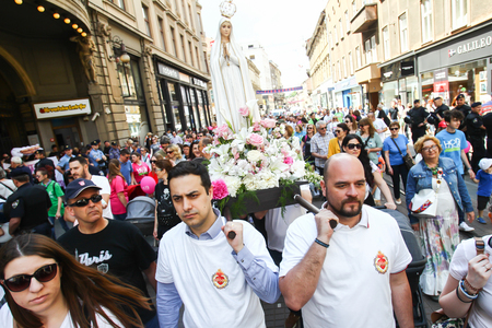 ZAGREB,CROATIA - MAY 19, 2018 : People carrying a Virgin Mary statue while marching against...