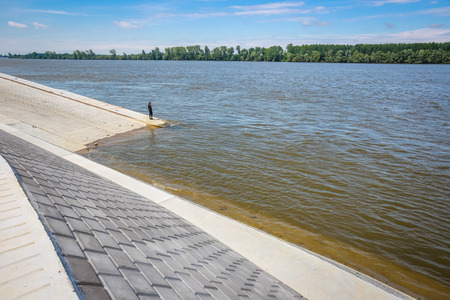 Man standing on a new embankment on the shore of river Danube in Vukovar, Croatia. Danube is Europes...