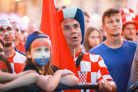 ZAGREB, CROATIA - JUNE 16TH, 2018 : Croatian football fans watching on the big screen football game of Croatia vs Nigeria on Fifa World cup 2018 on Ban Jelacic Square in Zagreb, Croatia.のeditorial素材
