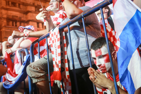ZAGREB, CROATIA - JULY 7TH, 2018 : Croatian football fan praying for win of Croatia of quarterfinal game Croatia vs Russia on Fifa World cup 2018 on Ban Jelacic Square in Zagreb, Croatia.のeditorial素材