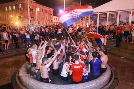 ZAGREB, CROATIA - JULY 11, 2018 : Croatian football fans celebrating victory of 2:1 Croatia vs England in semifinales Fifa World cup 2018 in water fountain Mandusevac on Ban Jelacic Square.のeditorial素材