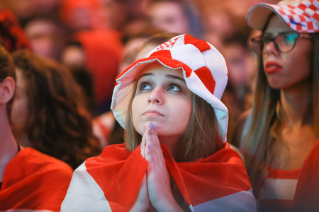ZAGREB, CROATIA - JULY 11, 2018 : Croatian football woman fan all worried watching the match of Croatia vs England semi finale Fifa World cup 2018 on Ban Jelacic Square in Zagreb, Croatia.のeditorial素材