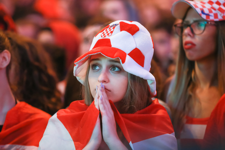 ZAGREB, CROATIA - JULY 11, 2018 : Croatian football woman fan all worried watching the match of Croatia vs England semi finale Fifa World cup 2018 on Ban Jelacic Square in Zagreb, Croatia.のeditorial素材