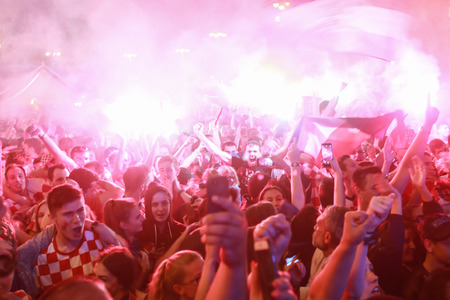 ZAGREB, CROATIA - JULY 11, 2018 : Croatian football fans celebrating victory of 2:1 Croatia vs England in semi finales Fifa World cup 2018 on Ban Jelacic Square in Zagreb, Croatia.のeditorial素材