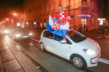 ZAGREB, CROATIA - JULY 11, 2018 : Croatian football fans celebrating victory of 2:1 Croatia vs England in semi finales Fifa World cup 2018 on the streets of Zagreb, Croatia.のeditorial素材