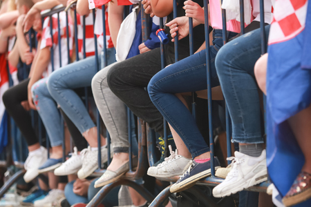 A group of Croatian football fans with the same leg position at the welcome home ceremony while waiting for the national team to arrive in Zagreb, Croatia.の写真素材