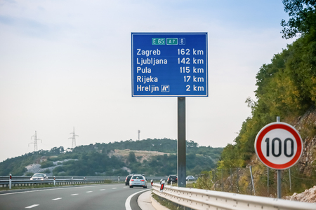 Rijeka, Croatia - August 1th, 2018 : Traffic on the Rijeka Bypass, highway from Smrika place to Hreljin with sign of main cities distance and speed limit of 100 km/h in Rijeka, Croatia.のeditorial素材