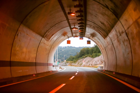 Curved empty highway tunnel with exit on the end.の写真素材