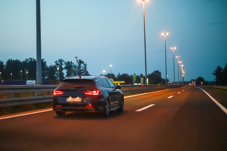 Car driving on the highway at sunset.