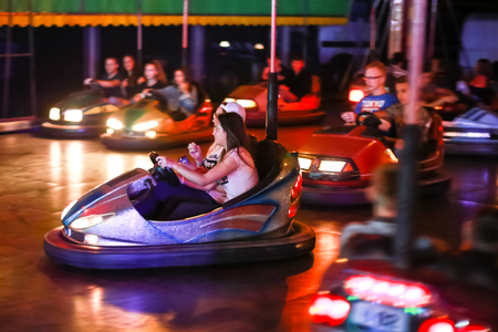 Vukovina, Croatia - August 15, 2018 : People riding on bumper cars in an amusement park on a fair in Vukovina, Croatia.のeditorial素材