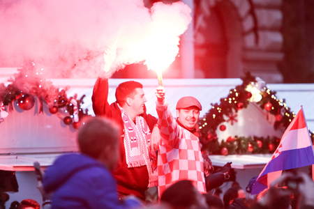 ZAGREB, CROATIA - NOVEMBER 26, 2018 : Croatia National Tennis Team welcome home celebration on the Ban Jelacic Square. Spectators light up red torch in the crowd.のeditorial素材