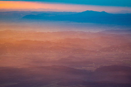 A view of the sunset over the village and mountain peaks.
