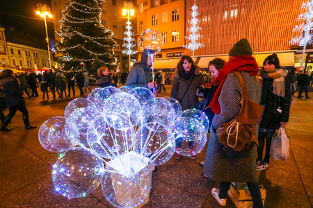 Zagreb, Croatia - December 29, 2018: People buying an illuminating led balloon in the Jelacic square at advent time in Zagreb, Croatia.のeditorial素材