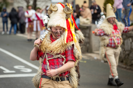 Matulji, Croatia - 3rd February, 2019 : Traditional carnival parade of bellringers with big cattle bells passing thru the street of Matulji, during the carnival procession.のeditorial素材