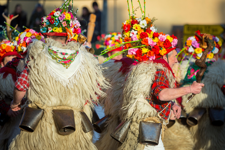 Matulji, Croatia - 3rd February, 2019 : Traditional carnival parade of bellringers with big cattle bells passing thru the street of Matulji, during the carnival procession.のeditorial素材