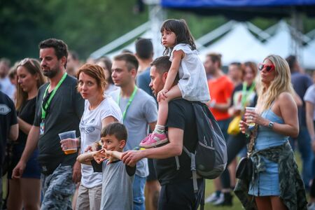 Zagreb, Croatia - 24th June, 2019 : Atmosphere during the 14th INmusic festival located on the lake Jarun in Zagreb, Croatia. Parents with kids listen to the concert during festival.のeditorial素材