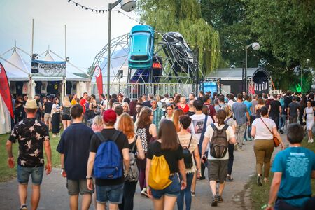 Zagreb, Croatia - 25th June, 2019 : Atmosphere during 2nd day of the 14th INmusic festival located on the lake Jarun in Zagreb. Rear view of large group of people walking on the path during festival.のeditorial素材