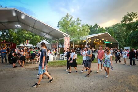 Zagreb, Croatia - 25th June, 2019 : Atmosphere during 2nd day of the 14th INmusic festival located on the lake Jarun in Zagreb, Croatia. People passing by food and drink tents on the festival.のeditorial素材