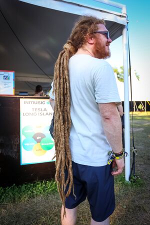Zagreb, Croatia - 26th June, 2019 : Visitors of 3rd day of the 14th INmusic festival located on the lake Jarun in Zagreb, Croatia. Rear view of caucasian man with long dreadlocks, posing.のeditorial素材