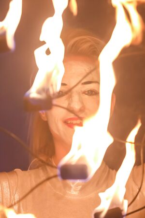 Brezje, Croatia - 19th July, 2019 : A woman juggling with a fire on the stage on the Forestland,...