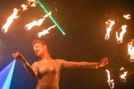 Brezje, Croatia - 19th July, 2019 : A woman juggling with a fire on the stage on the Forestland,...