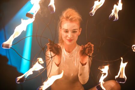 Brezje, Croatia - 19th July, 2019 : A woman juggling with a fire on the stage on the Forestland,...